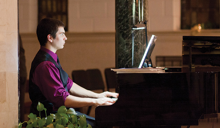 Student playing piano in Chapel